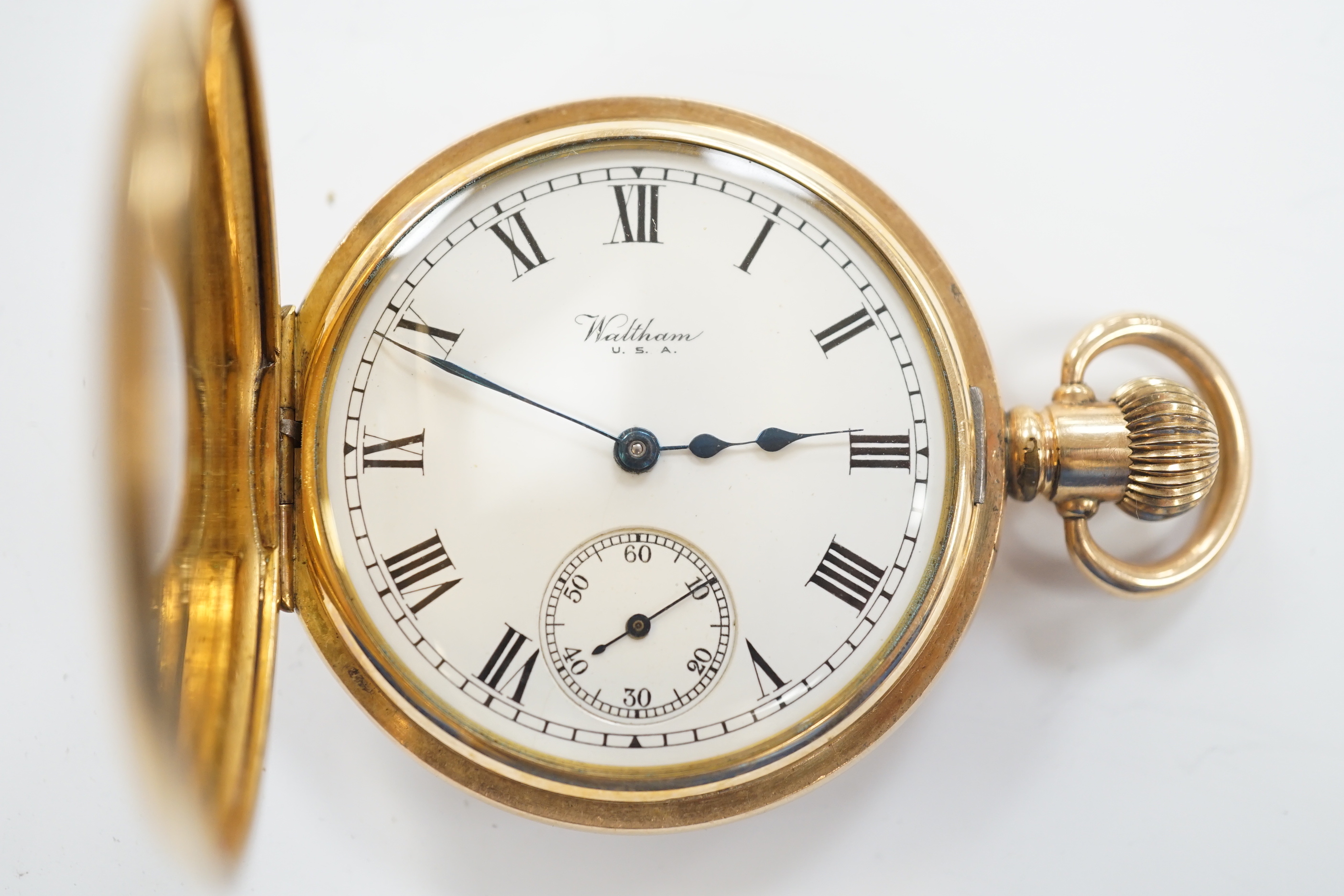 A gold plated Waltham half hunter keyless pocket watch, with Roman dial and subsidiary seconds.